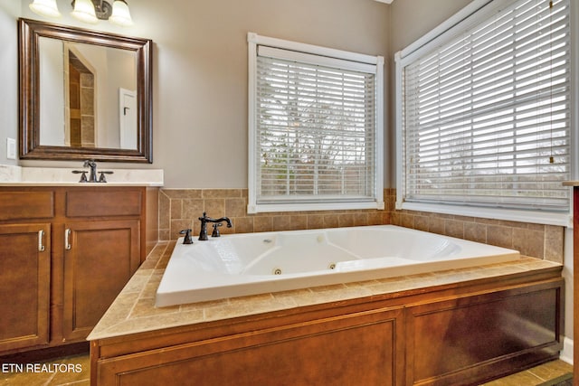 bathroom featuring vanity and a bath