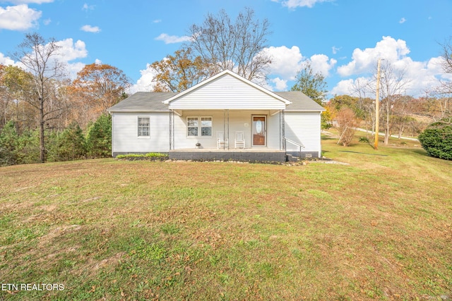 view of front of home featuring covered porch and a front lawn