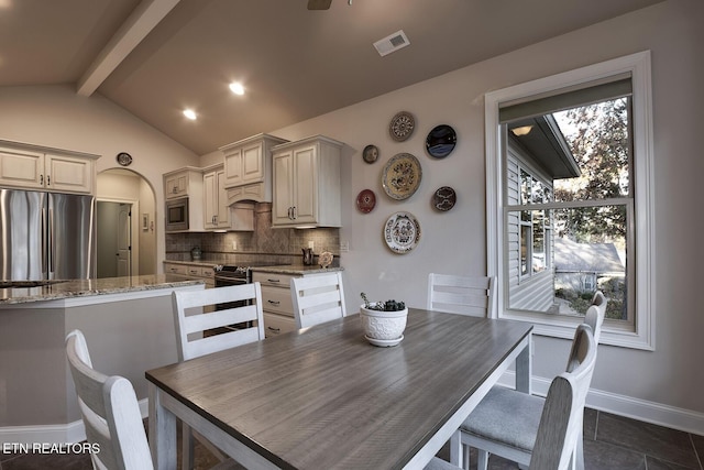 dining space with lofted ceiling with beams and ceiling fan