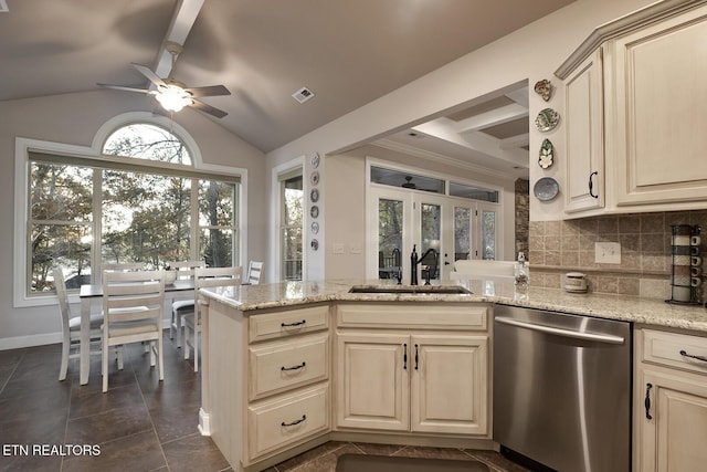 kitchen featuring backsplash, light stone countertops, sink, and dishwasher