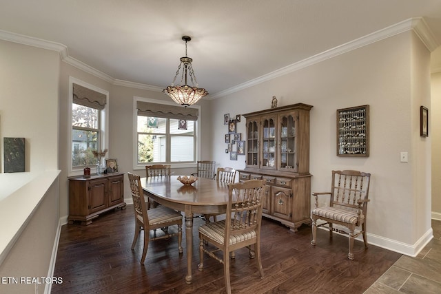 dining area featuring dark hardwood / wood-style flooring and ornamental molding