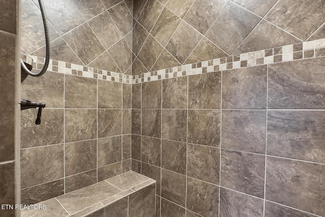 bathroom with tiled shower