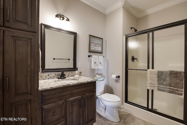 bathroom with tile patterned floors, toilet, a shower with shower door, ornamental molding, and vanity