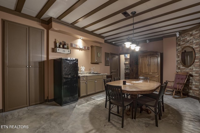 dining area with beam ceiling and indoor wet bar