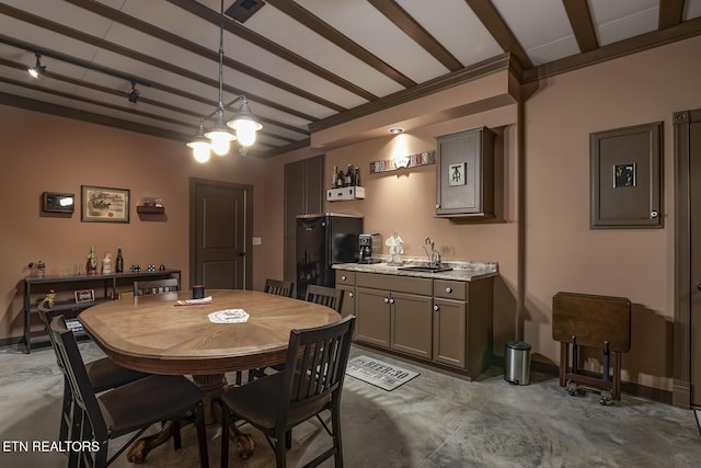 dining space with sink, beam ceiling, and ornamental molding