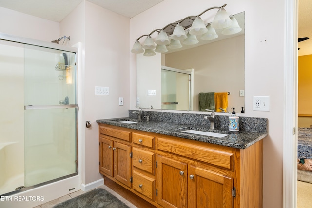 bathroom with tile patterned flooring, vanity, and a shower with shower door