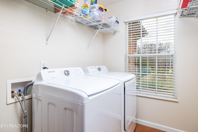 clothes washing area with tile patterned floors and washer and dryer