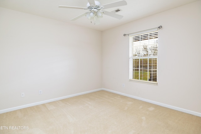 carpeted empty room featuring ceiling fan