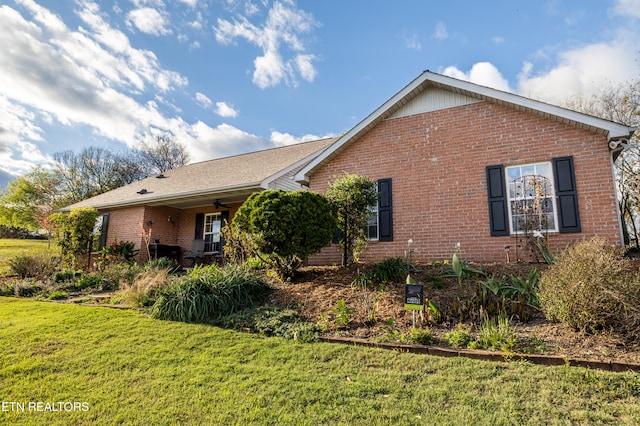 view of property exterior with a lawn