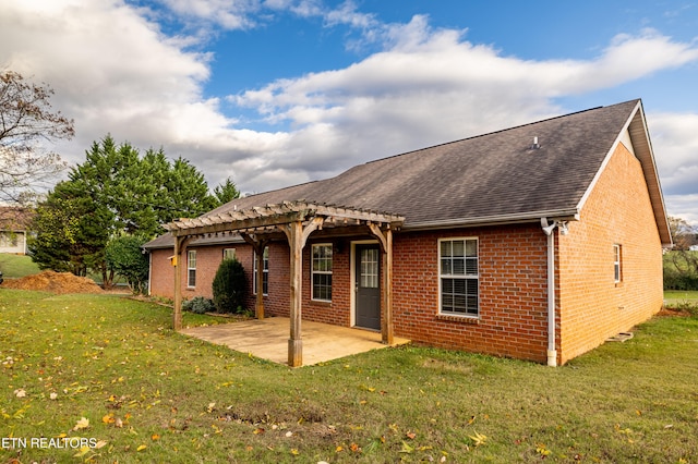 back of house featuring a pergola, a patio area, and a yard