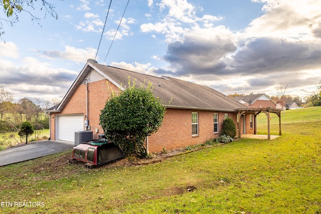 view of property exterior featuring a lawn, cooling unit, and a garage