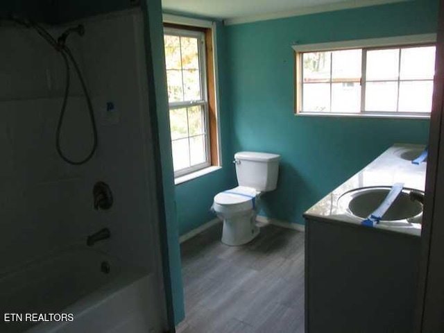 full bathroom featuring shower / bath combination, vanity, hardwood / wood-style flooring, and toilet