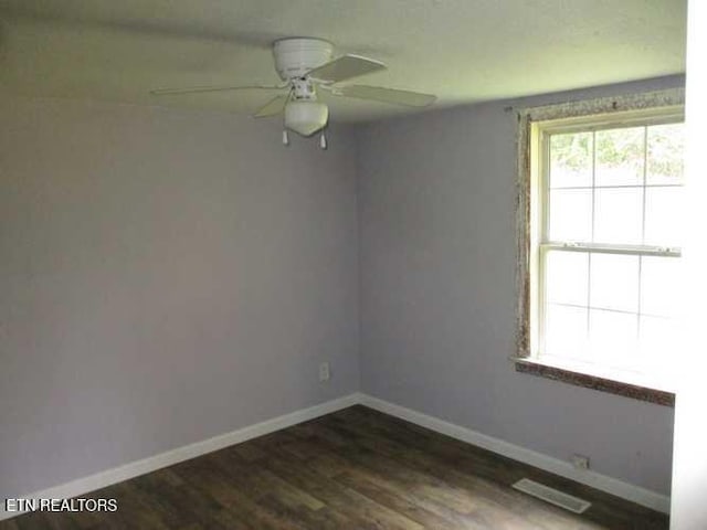 empty room featuring ceiling fan and dark hardwood / wood-style floors