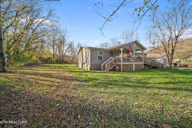 back of property featuring a yard