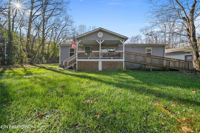 back of house with a yard and a wooden deck