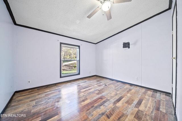 spare room featuring ceiling fan, crown molding, a textured ceiling, and dark wood-type flooring