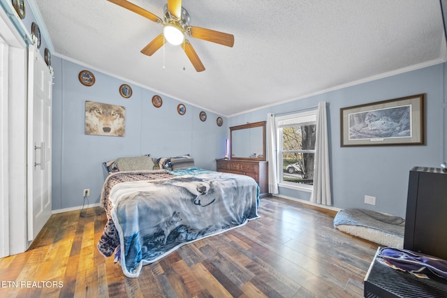 bedroom with ceiling fan, wood-type flooring, and a textured ceiling