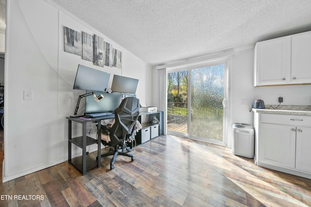 interior space featuring a textured ceiling, hardwood / wood-style flooring, and ornamental molding