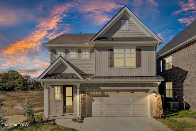 view of front of home featuring a garage and central air condition unit