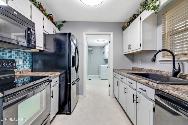 kitchen with white cabinetry, sink, washer / dryer, decorative backsplash, and appliances with stainless steel finishes