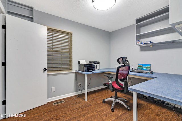 office with a textured ceiling and dark wood-type flooring