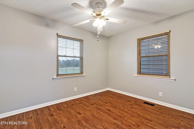 spare room with hardwood / wood-style flooring, ceiling fan, and a textured ceiling