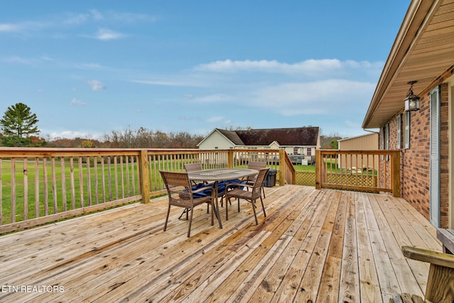 wooden deck with a lawn