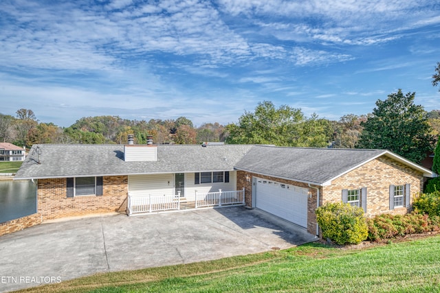 ranch-style house featuring a garage and a front yard