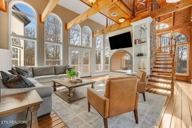 sunroom featuring french doors and lofted ceiling with beams