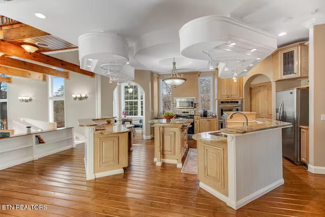 kitchen featuring sink, wood-type flooring, a kitchen island with sink, and stainless steel appliances