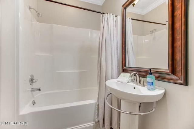 bathroom featuring crown molding and shower / bath combo