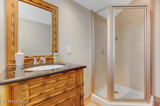 bathroom featuring tile patterned flooring, vanity, and an enclosed shower