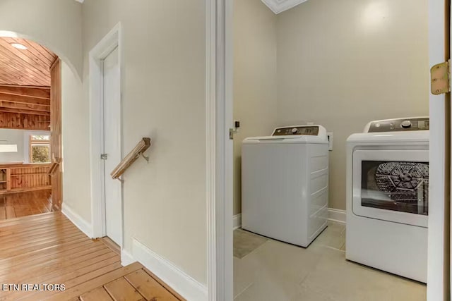 washroom with washer and dryer and light wood-type flooring