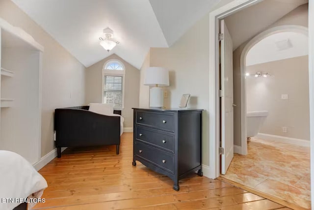 bedroom featuring light wood-type flooring and lofted ceiling