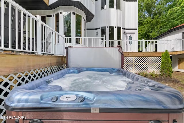 view of patio / terrace with a deck and a hot tub