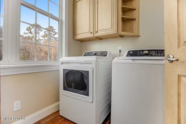 washroom featuring cabinets, separate washer and dryer, and dark wood-type flooring