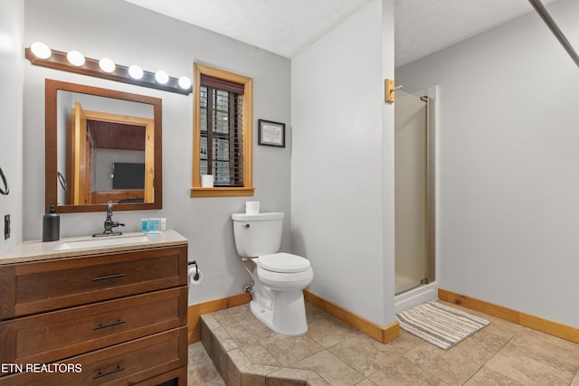 bathroom with vanity, a textured ceiling, toilet, and a shower with door