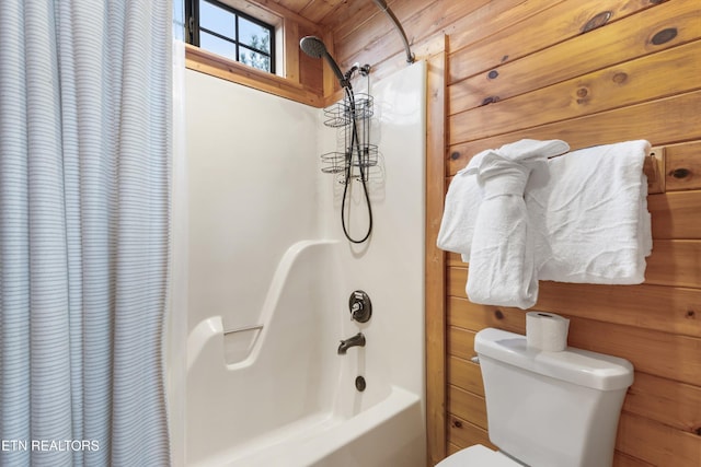 bathroom featuring wood walls, toilet, wood ceiling, and shower / tub combo with curtain