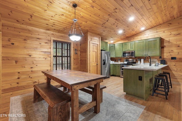 dining area with light wood-type flooring, vaulted ceiling, sink, wooden ceiling, and wood walls