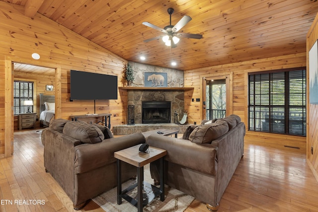 living room with light hardwood / wood-style floors, a healthy amount of sunlight, and wood ceiling