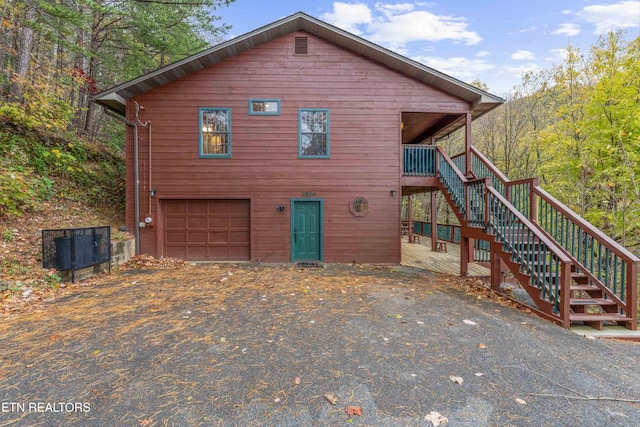 view of front of home with a garage and a wooden deck