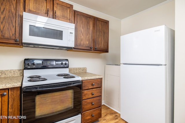 kitchen with white appliances, light countertops, light wood-type flooring, and ornamental molding