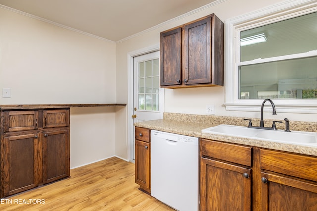 kitchen featuring sink, a healthy amount of sunlight, light hardwood / wood-style flooring, crown molding, and white dishwasher