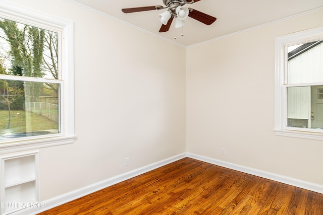 unfurnished room with ceiling fan, baseboards, wood finished floors, and crown molding