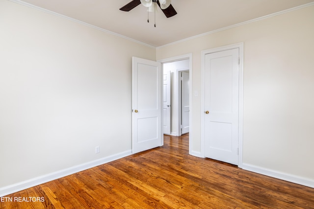 unfurnished room featuring crown molding, dark hardwood / wood-style flooring, and ceiling fan