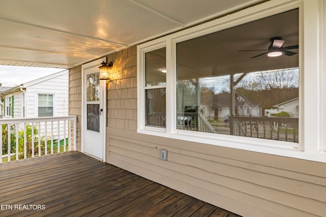 wooden deck with a porch and ceiling fan