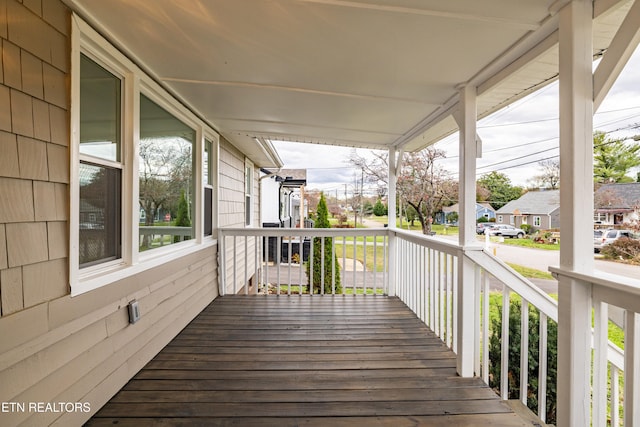 deck with a residential view and a porch