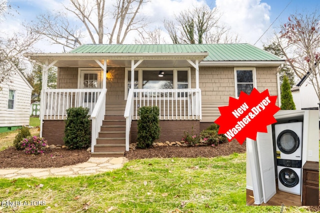 view of front of house featuring covered porch, washer / clothes dryer, and metal roof