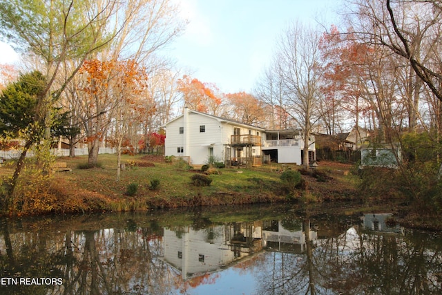 back of house featuring a water view and a sunroom