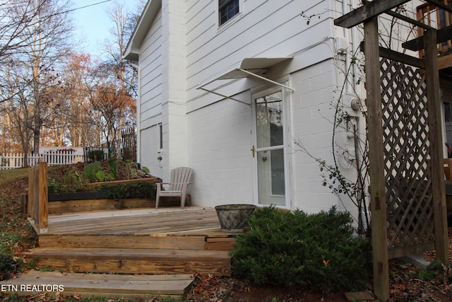 view of side of home with a wooden deck